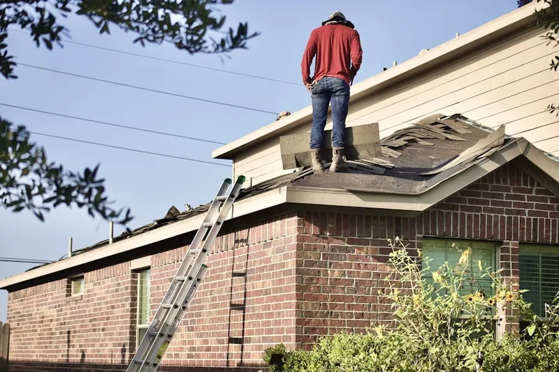 Professional roofer working on a residential roof in Belford